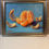 Thumbnail: A still life oil painting of a glowing peeled orange in segments.