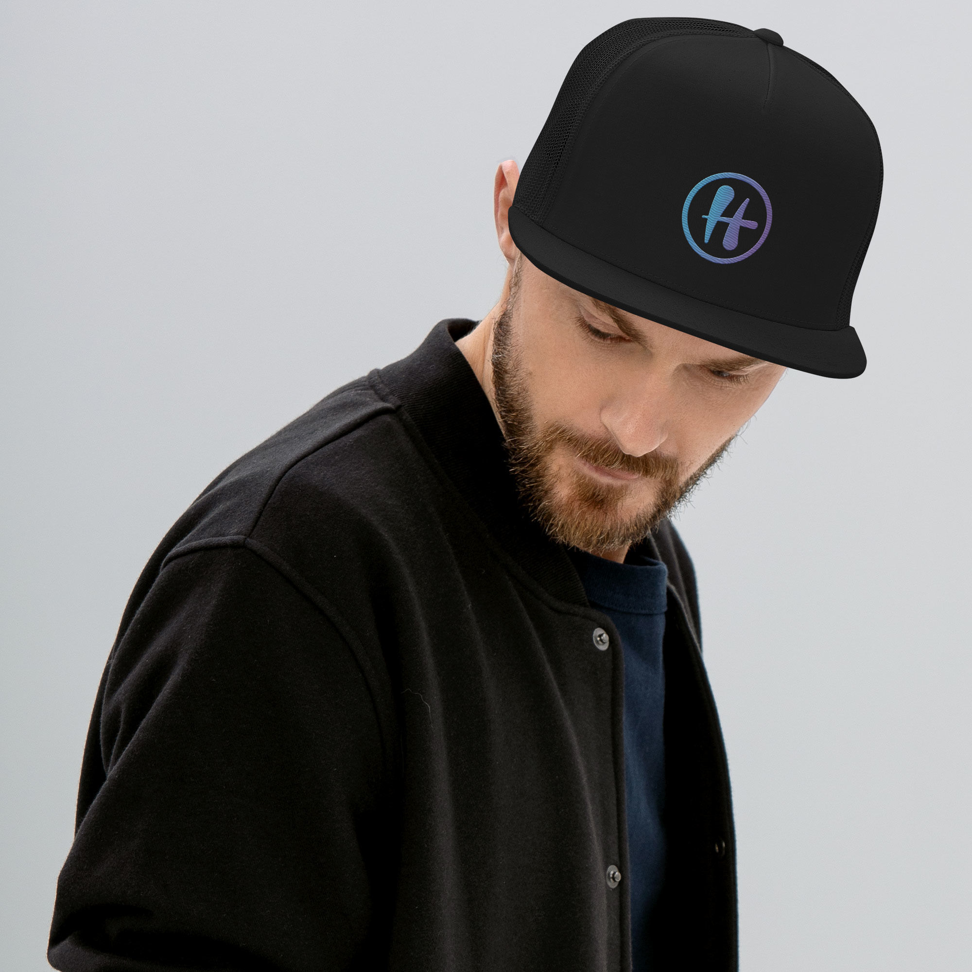 Person wearing black Hugs trucker cap
