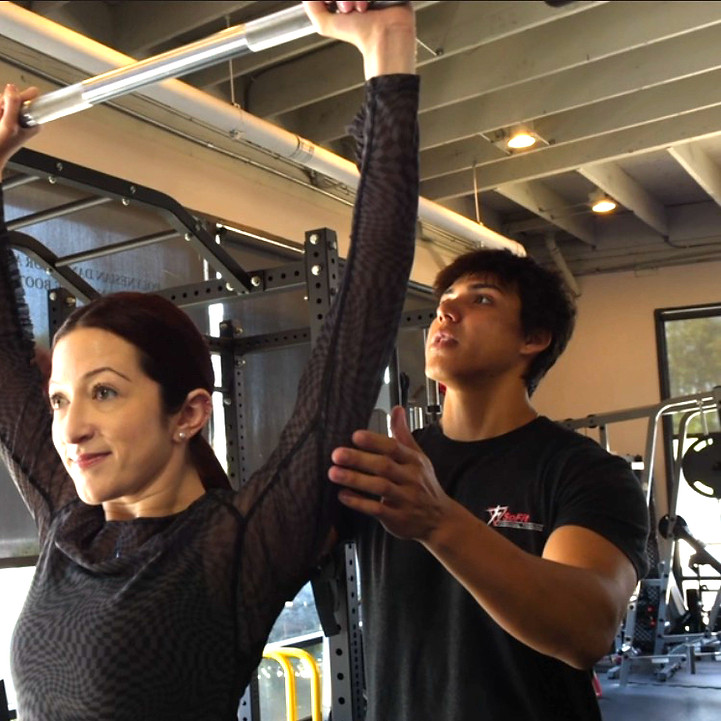 Personal Trainer Dru spotting during shoulder assist_edited.jpg