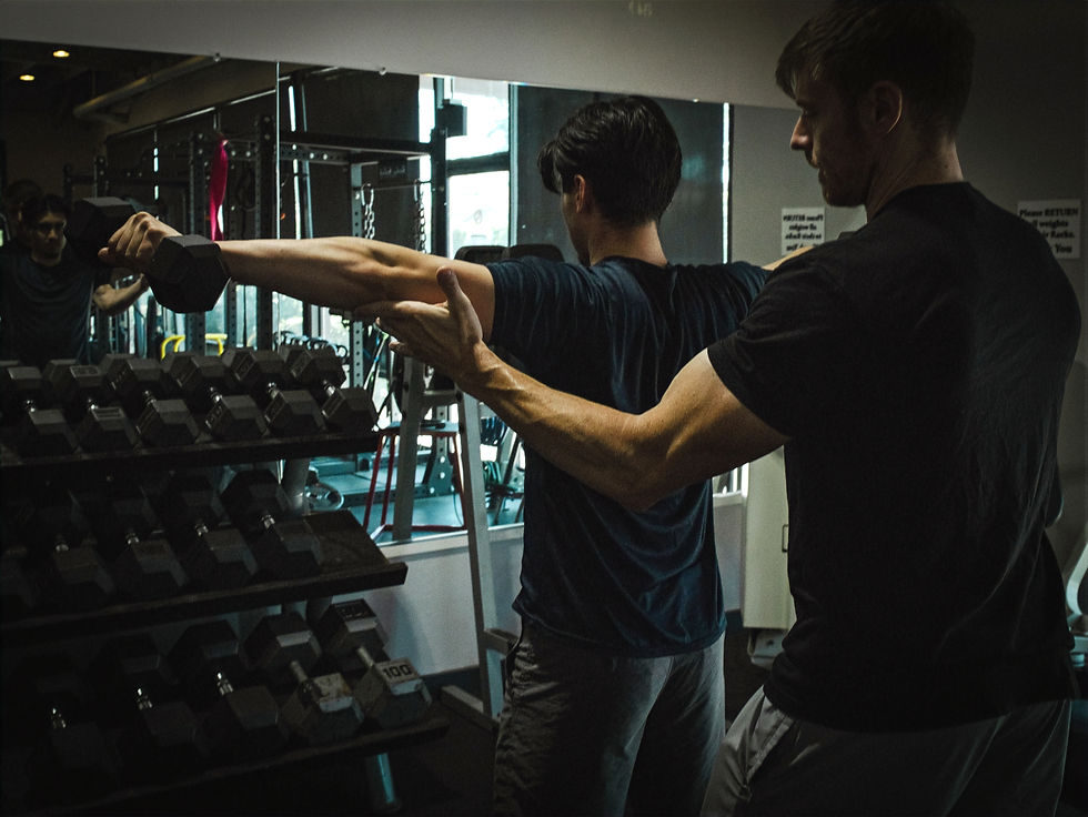 Personal Trainer Tommy spotting shoulder exercise