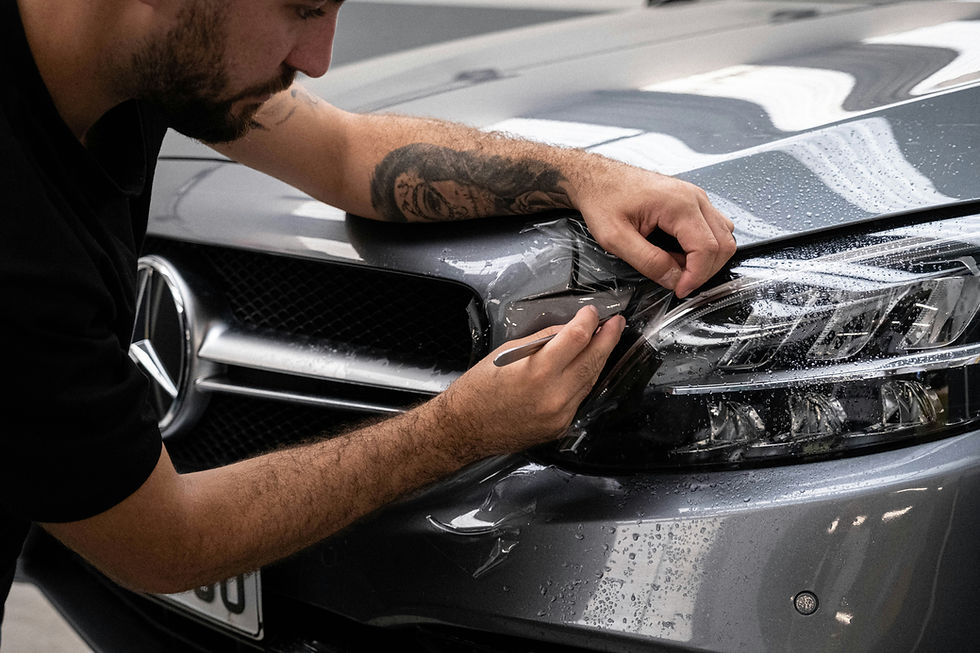 man detailing headlights