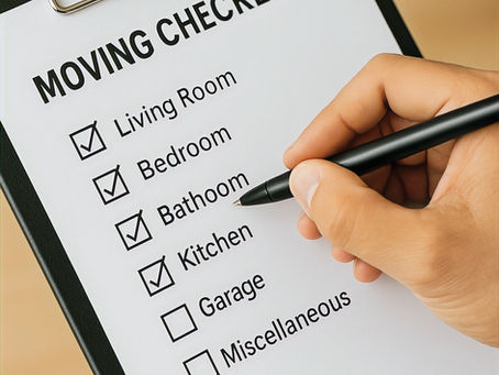 A clipboard with a persons hand holding a pen checking off items on a moving checklist
