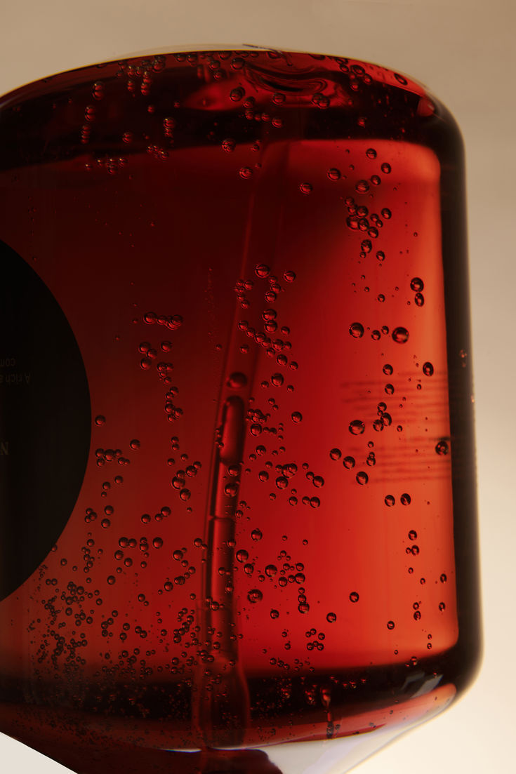 Thumbnail: An unclose photo of a glass cup filled with Osia Ease Elixir.