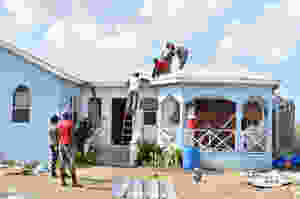 Contractors re-roofing home damaged by Irma on island of Barbuda as part of UN relief projected sponsored by China.