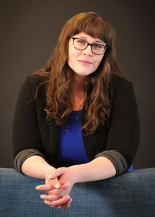 Author headshot in studio against black background