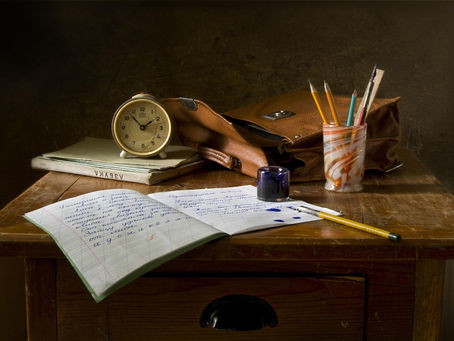 Vintage writing desk with notebook, pencils, and clock — a quiet workspace representing thoughtful Chicago style editing.