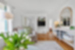 Living room with modern decor, flat-screen TV, and plants