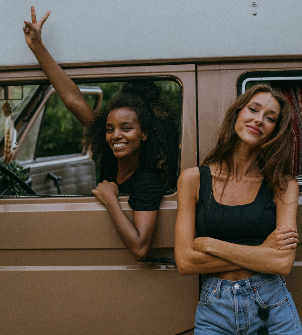 two happy women traveling by van.jpeg