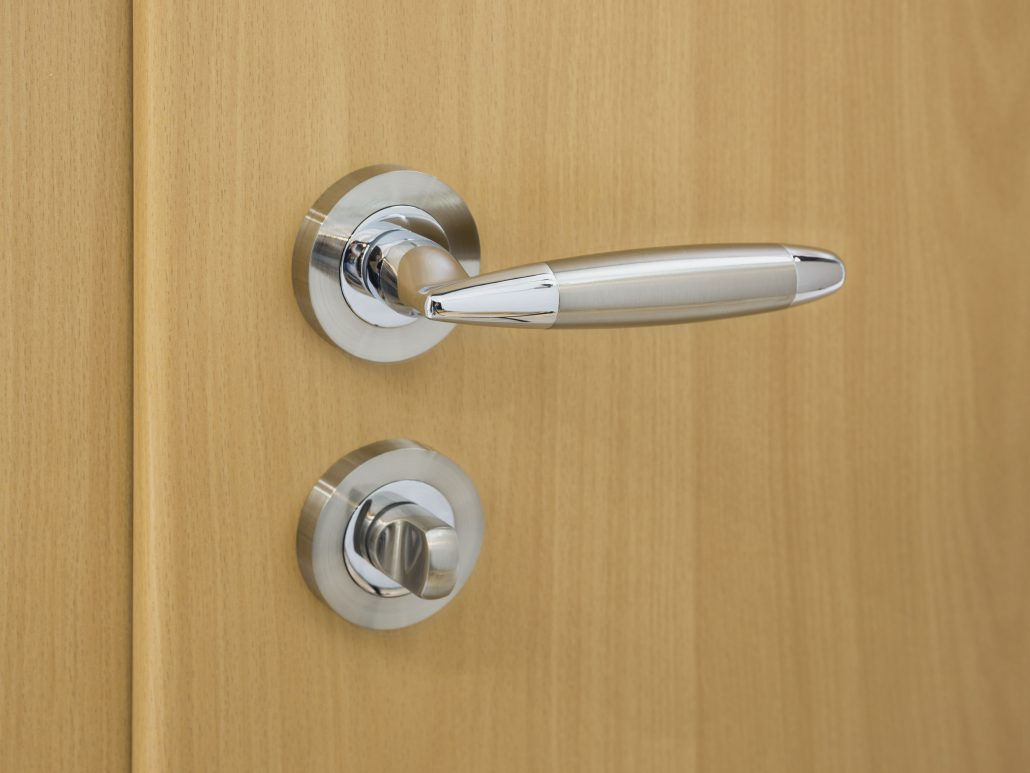 Homenetics Vela Interior Door Lever in two-tone polished chrome with ergonomic design
