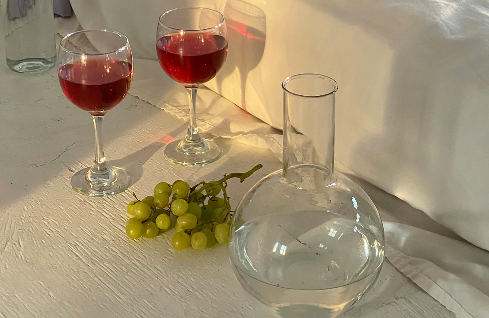 wine glass, grapes and flask