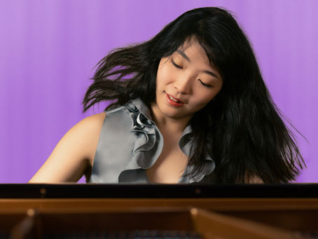 claire huangci playing piano with pink dreamy background