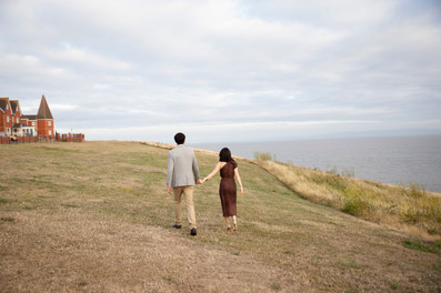 Couple walking side by side along the beach during a documentary style photoshoot in South Wales