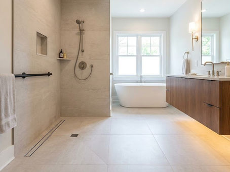 Modern accessible bathroom featuring a curbless shower, linear drain, integrated grab bar, floating vanity, handheld shower, recessed niche, and freestanding bathtub.