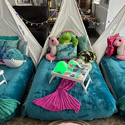 Close up photograph of one of three teepees with a seahorse and multiple sea turtles.