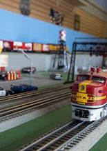 A model red and silver train in a miniature city with various city models.
Photo & description: travelok.com