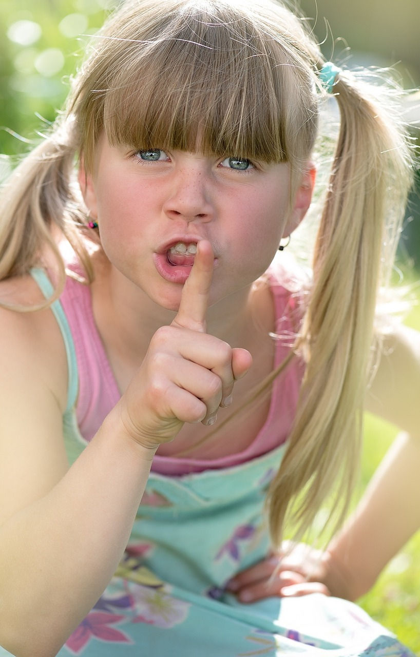 Blond girl shushing