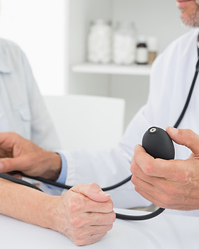 Doctor taking blood pressure of older pa