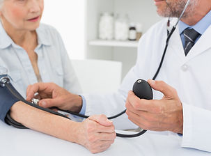 Doctor taking blood pressure of older pa