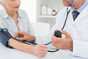 doctor taking geriatric patient's blood pressure