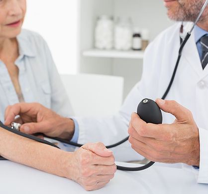 Doctor taking blood pressure of older pa