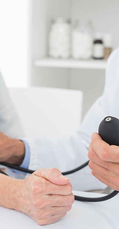 Doctor taking blood pressure of older patient