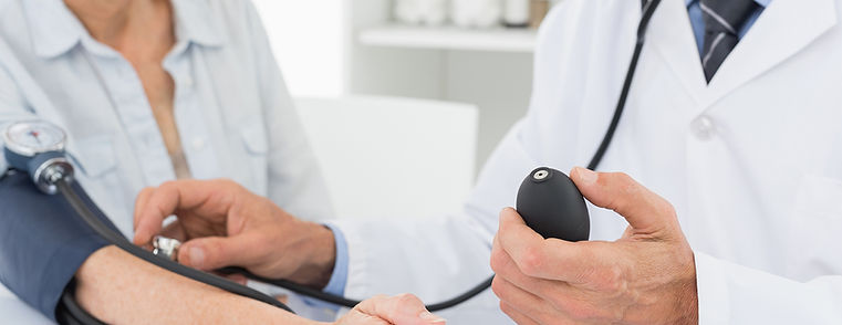 Doctor taking blood pressure of older pa