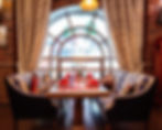 restaurant-table-with-two-couches-near-window.jpg