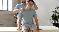 man-helping-patient-physiotherapy-full-shot.jpg