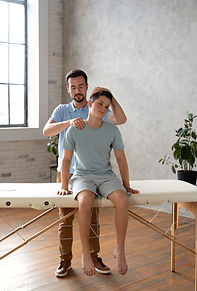 man-helping-patient-physiotherapy-full-shot.jpg