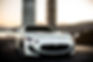 white-coupe-sport-car-standing-road-front-view.jpg