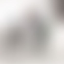 Person doing a simple standing stretch at a desk, showing how short exercise snacks can fit into a workday.