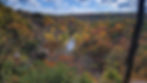 Scenic river in autumn valley with vibrant fall foliage