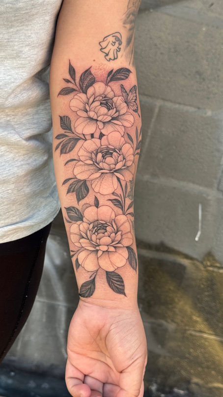 A beautiful dainty fine line floral tattoo done in downtown Fresno by Alex Meza Tattoos