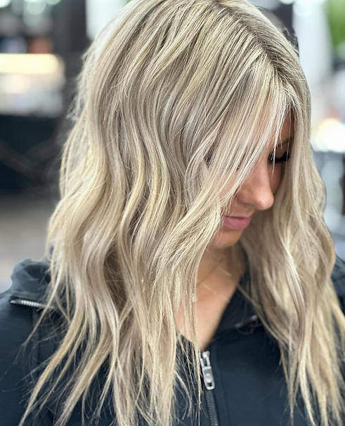 young woman with medium length hair and blonde highlights