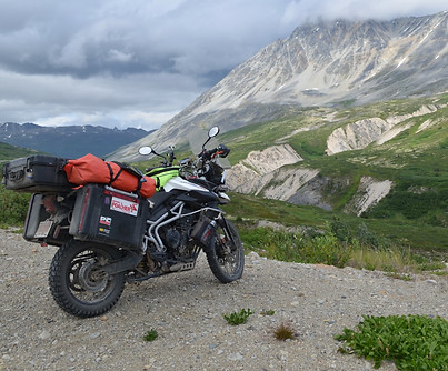 An Adventure Motorcycle parked near a picturesque valley