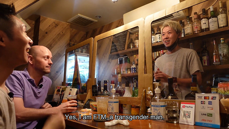 Two cis men sitting at a bar, speaking to a trans man, in the interview titled We Went to an FTM Trans Bar in Tokyo