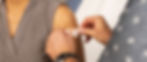 Person putting a band-aid on someone's shoulder.