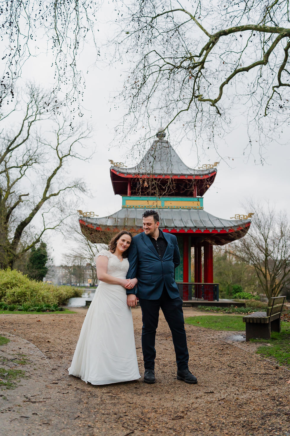 Bride and groom pose Infront of the Chinese Pagola in Victoria park, London