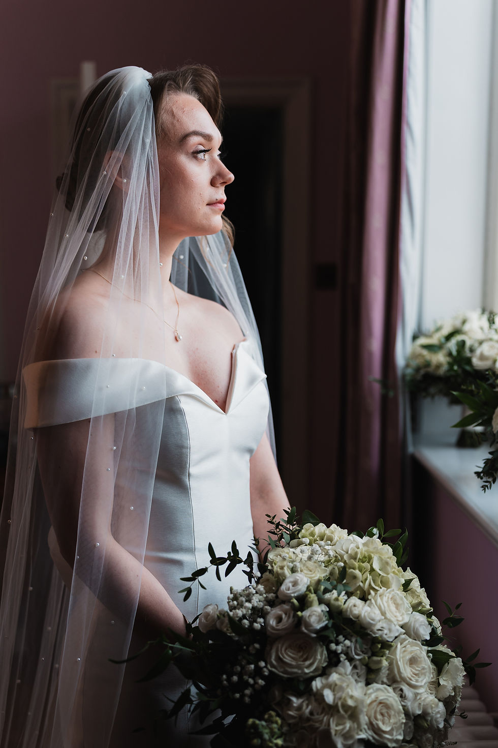Lauren the bride looking out of a window in St Giles hotel