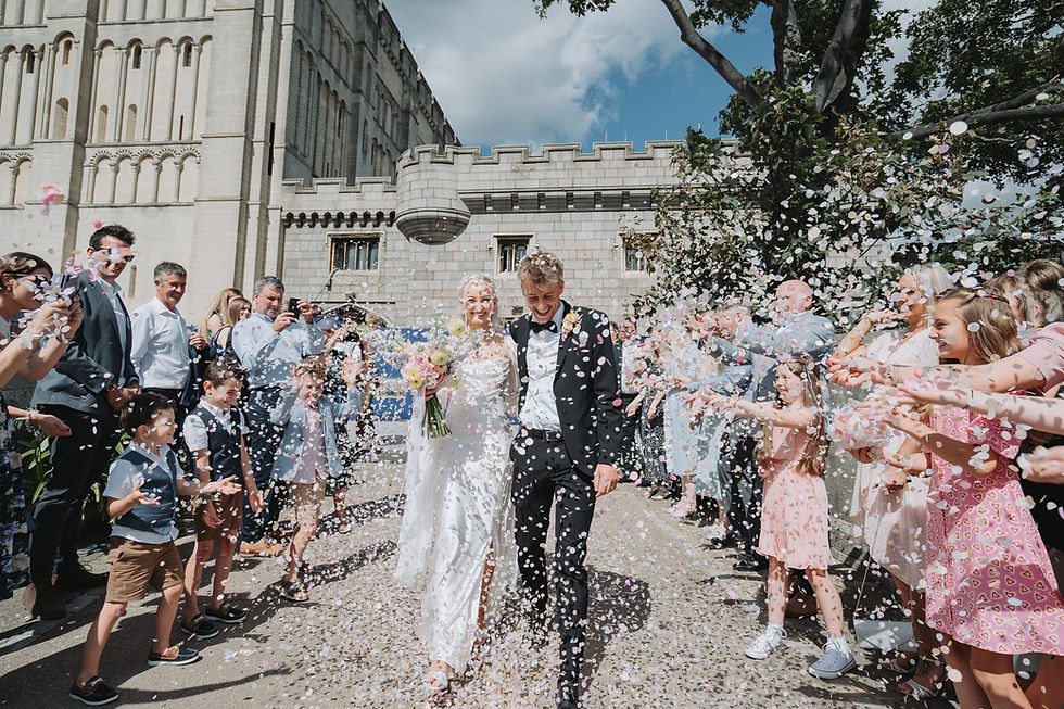 couple walk through confetti at norwich castle