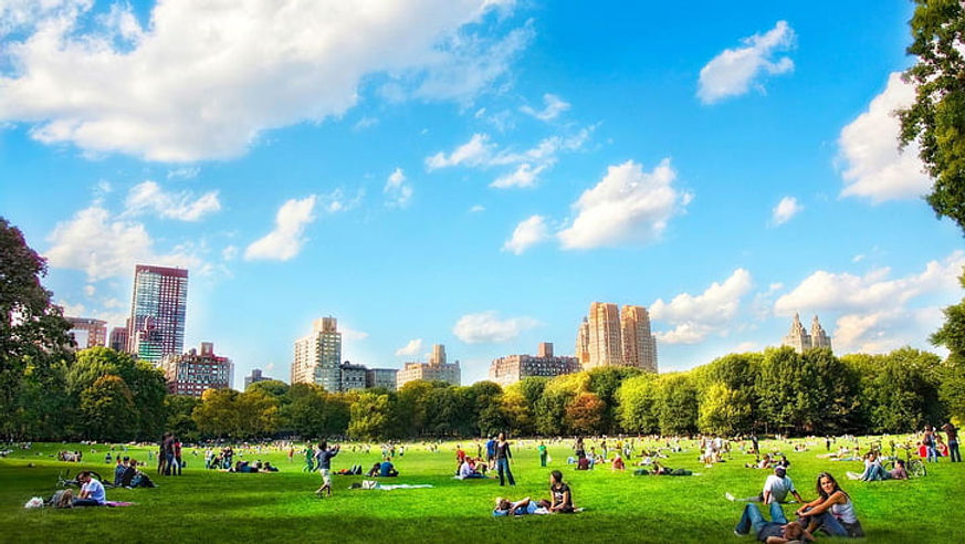 People enjoying a sunny day sitting on the grass in Hyde Park, surrounded by nature and greenery. People enjoying a sunny day sitting on the grass in Hyde Park, surrounded by nature and greenery.