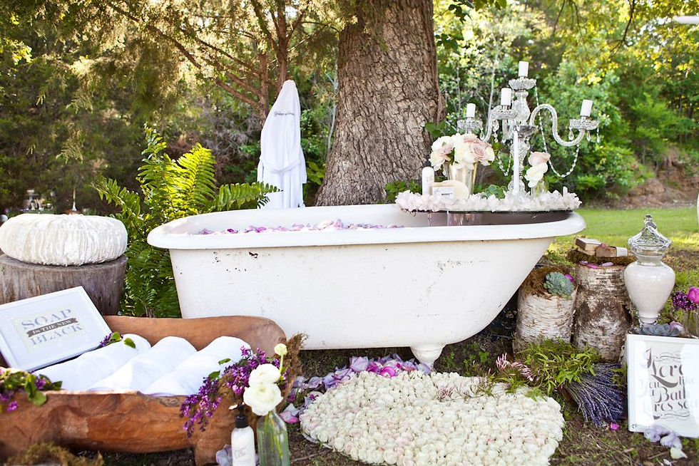 Bathtub adorned with flowers and candles, part of a French bridal shower spa experience for the bride-to-be.