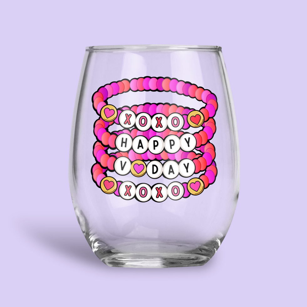 Stemless wine glass with beaded bracelets saying XOXO, HAPPY, VDAY, XOXO.