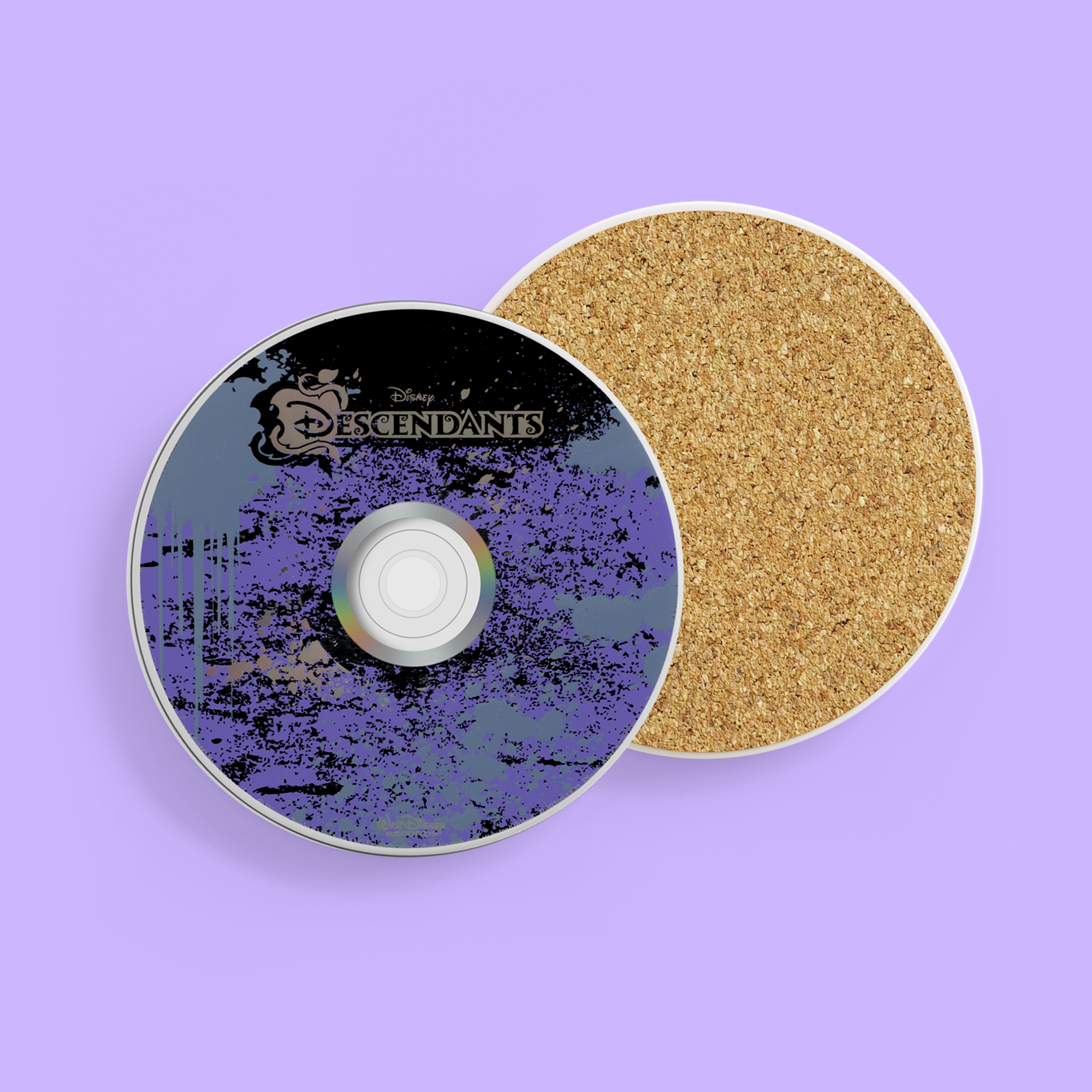 Descendants DVD and coaster on purple surface, with the movie logo visible.