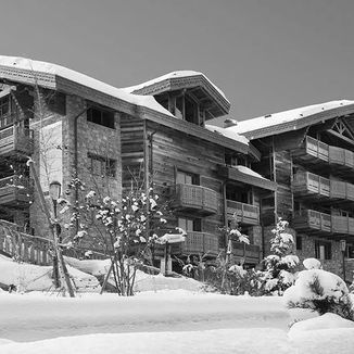 outdoor image of private chalet in courchevel, france covered in snow and made of wood
