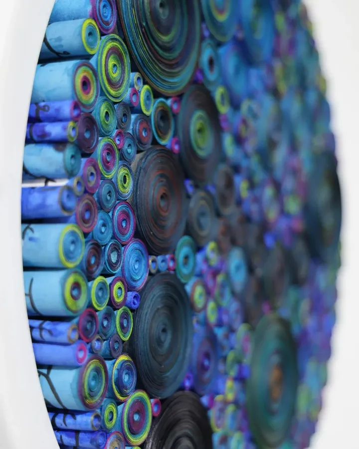 Artwork by Hadieh Shafie A circular painting featuring overlapping blue and green circles on a light background.