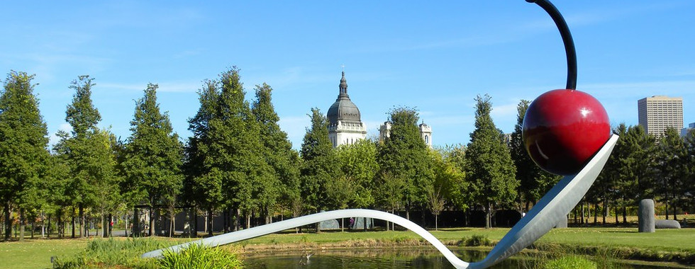 32. © Photo by Arthistory390 showing a large spoon sculpture in the middle of a lake in a park with a big cherry on top of the spoon