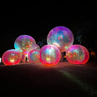 Outdoor art exhibition installation feature glowing human size bubbles at noor riyadh 2024 where artelier acted as artist liaisons