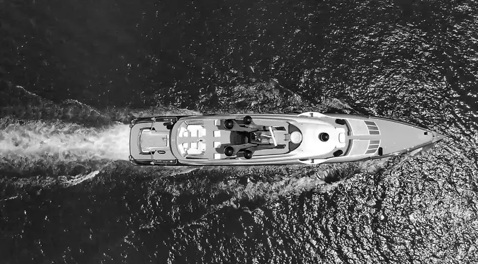 black and white bird eye's view of a private superyacht facing to the right as a background display to a testimonial by amels and damen yachting for artelier