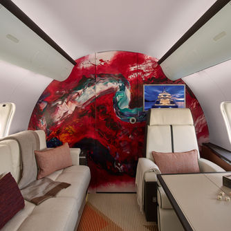 an example project by artelier art advisors for a bombardier global 5000 aircraft featuring a custom commission feature wall made of red paint